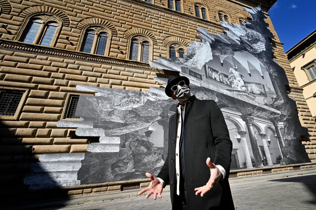 French artist JR poses during the unveiling of his visual installation "La Ferita."