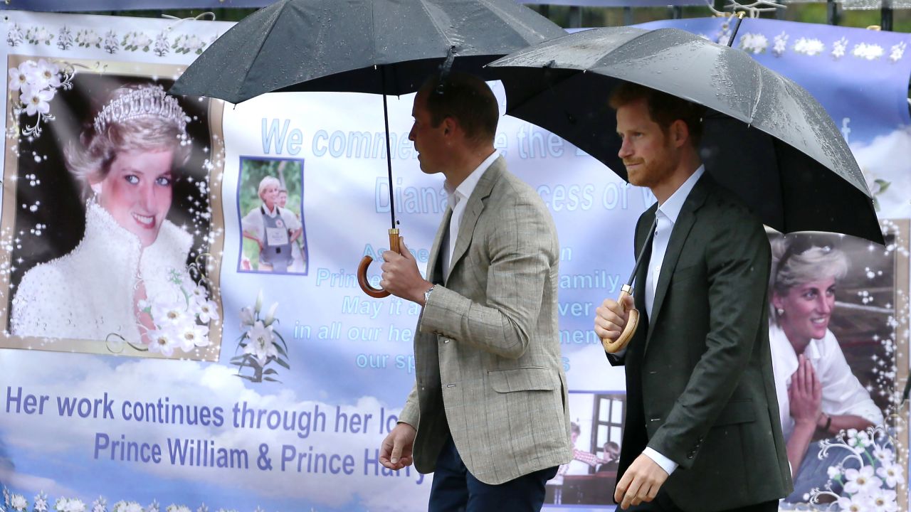William, left, and Harry look at tributes left outside Kensington Palace to mark the 20th anniversary of Diana's death in 2017.