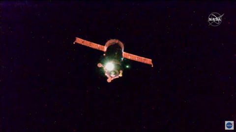 The space station passed through an orbital sunrise during the flight, reflecting red light off the spacecraft.
