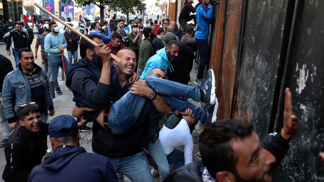 Protesters in Beirut climb a wall installed to prevent them from reaching parliament on March 13. 