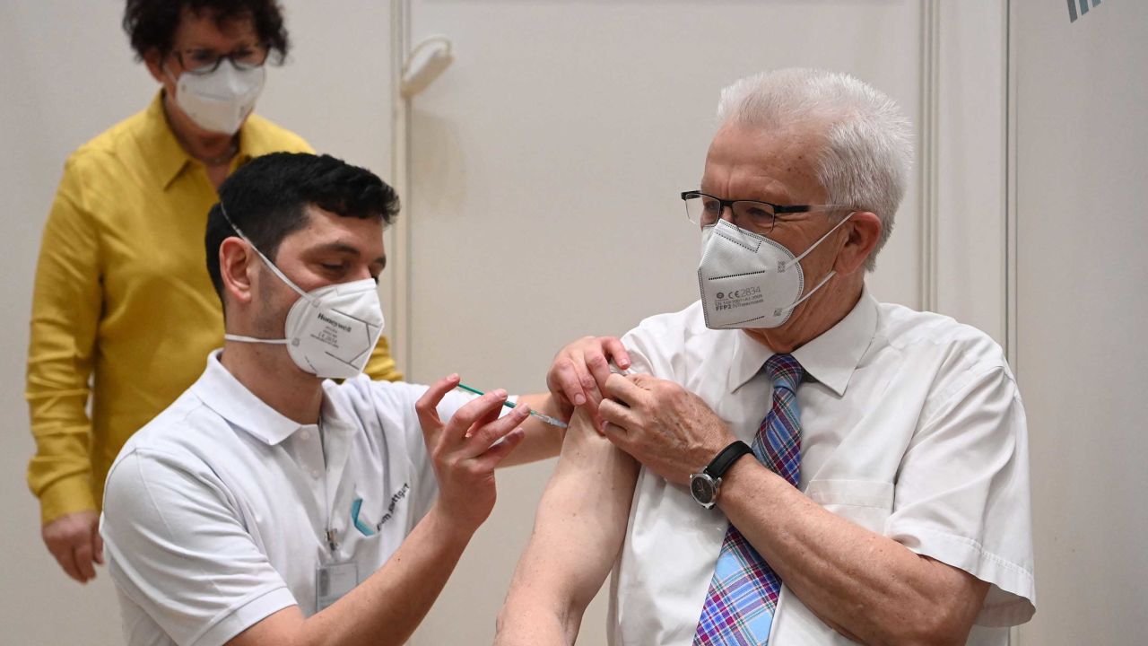 Baden-Wuerttemberg's State Premier Winfried Kretschmann, right, receives the AstraZeneca vaccine as his wife watches in Stuttgart, southern Germany, on March 19, 2021.