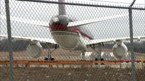 Trump's 757 is seen at Stewart Airport in New York in March 2021. The right engine wrapped in plastic, while the left engine appears to be removed.