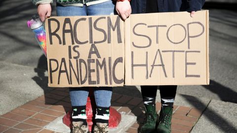 People hold signs during the "We Are Not Silent" rally against anti-Asian hate in Seattle, Washington in March. Throughout the coronavirus pandemic, many Western nations have marked a rise in Anti-Asian hate crimes.