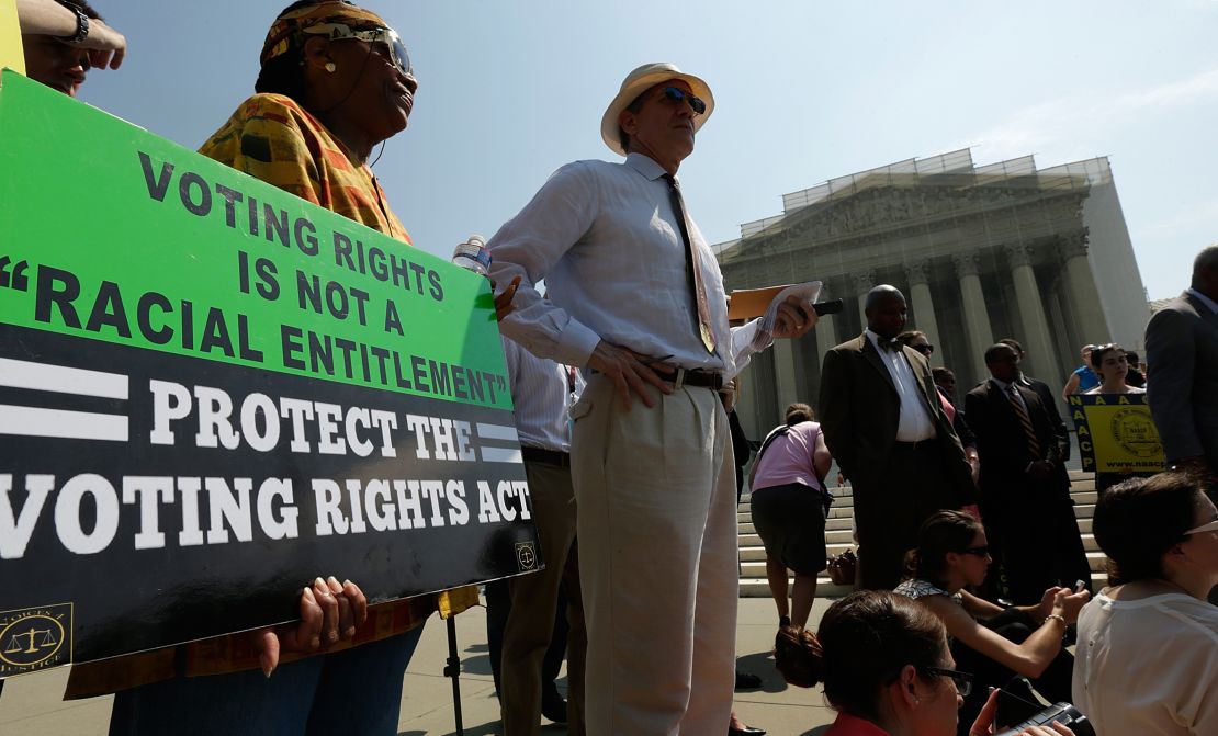Supporters of the Voting Rights Act listen to speakers discussing rulings outside the US Supreme Court building on June 25, 2013 in Washington.