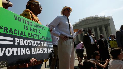 Supporters of the Voting Rights Act listen to speakers discussing rulings outside the US Supreme Court building on June 25, 2013 in Washington.