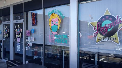 One of the servers painted a woman wearing a mask on the restaurant's window.