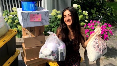 Alexa Mohsenzadeh, co-founder of Her Drive, holds up donated bras for the group's first Chicago-based drive in July of 2020. 