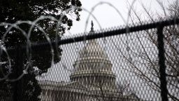 Security fencing in front of the U.S. Capitol in Washington, D.C., U.S., on Monday, Feb. 15, 2021. Donald Trump's allies lashed out at the Republican senators who voted to convict him in the impeachment trial touched off by last month's Capitol insurrection, showing the challenge the party would face in breaking with the former president after his acquittal. 