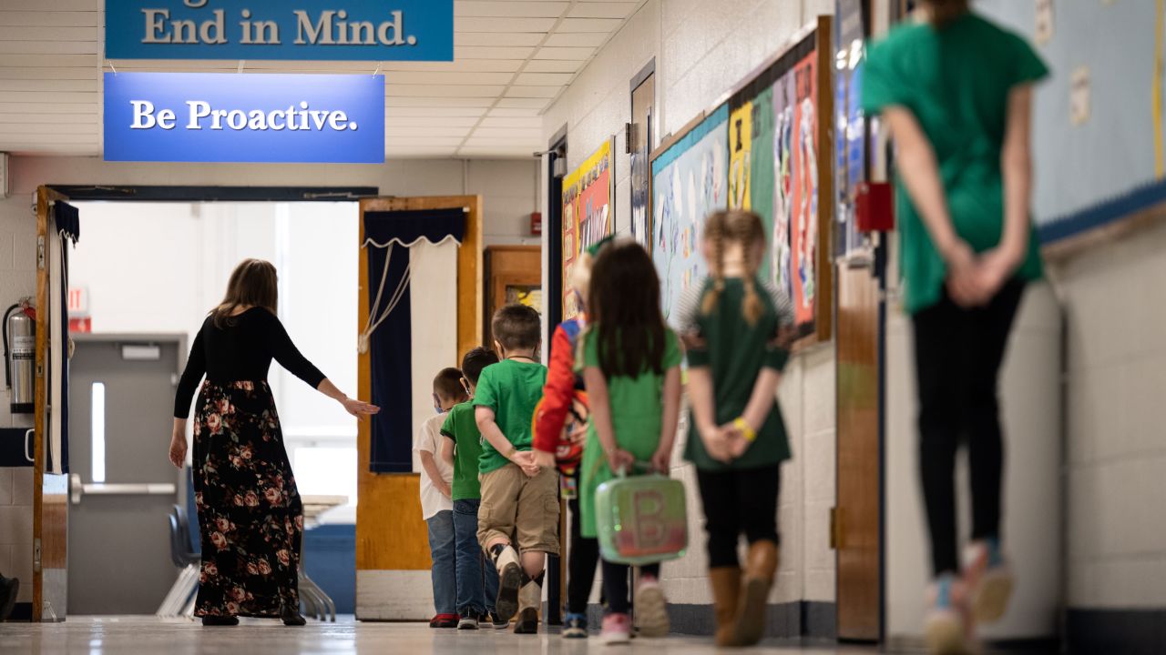 LOUISVILLE, KY - MARCH 17: Masked students march in line down the main hallway while socially distanced at Medora Elementary School on March 17, 2021 in Louisville, Kentucky. Today marks the reopening of Jefferson County Public Schools for in-person learning with new COVID-19 procedures in place. (Photo by Jon Cherry/Getty Images)