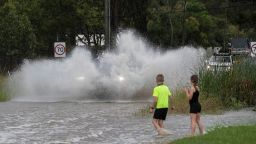 PENRITH, AUSTRALIA - MARCH 20: People watch as cars drive through flood waters on March 20, 2021 in Pitt Town, Australia. Heavy rain and flooding has trigger evacuations on the New South Wales mid coast with over 120mm rain expected for Sydney and residents urged to stay at home. (Photo by Brook Mitchell/Getty Images)
