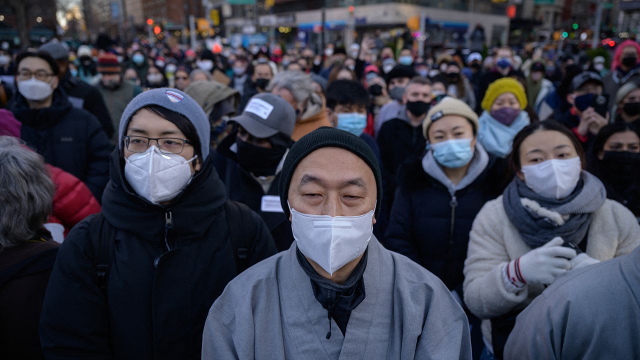 Members and supporters of the Asian-American community gather during a 'peace vigil' for victims of Asian attacks, at Union square in New York city on March 19, 2021. (Photo by Ed JONES / AFP) (Photo by ED JONES/AFP via Getty Images)