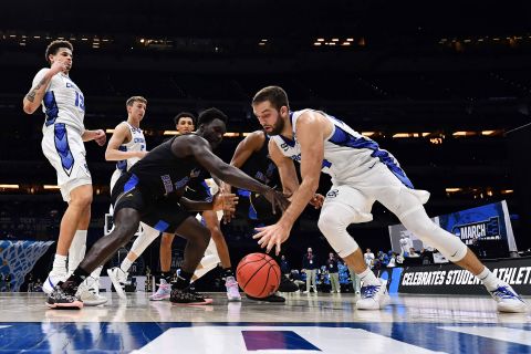 Creighton's Mitch Ballock, right, and UC-Santa Barbara's Amadou Sow reach for a loose ball during their first-round game.