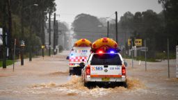TOPSHOT - State Emergency Service vehicles approach flooded residential areas in western Sydney on March 20, 2021, amid mass evacuations being ordered in low-lying areas along Australia's east coast as torrential rains caused potentially "life-threatening" floods across a region already soaked by an unusually wet summer. (Photo by Saeed KHAN / AFP) (Photo by SAEED KHAN/AFP via Getty Images)