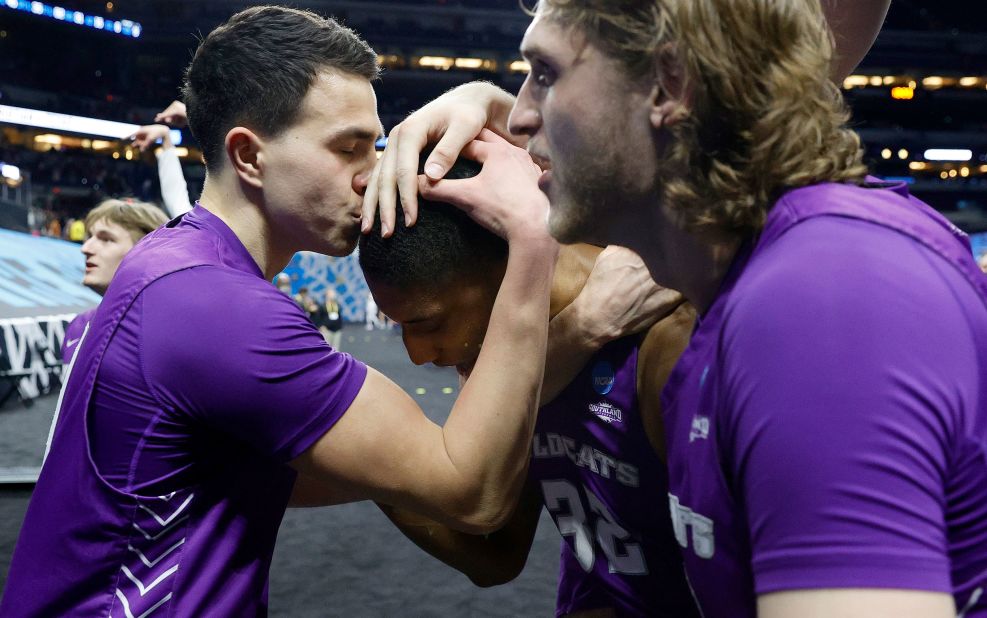 Tobias Cameron kisses the head of teammate Joe Pleasant after Pleasant's two clutch free throws gave Abilene Christian a 53-52 win over Texas on March 20. It was the last of several first-round upsets in this NCAA Tournament. Abilene Christian was a 14-seed. Texas was a 3-seed.