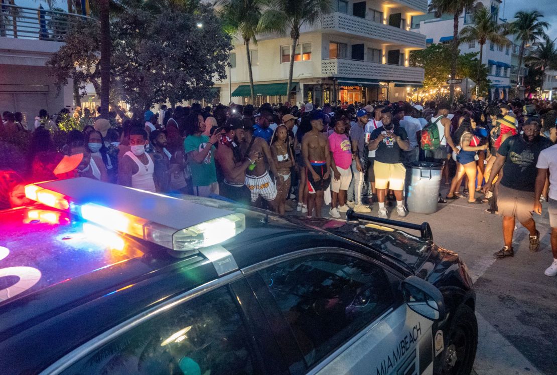 Miami Beach Police Department officers enforce an 8 p.m. curfew on Saturday night.