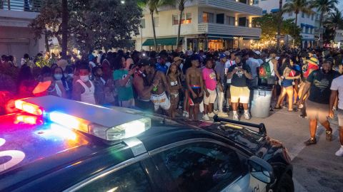 Miami Beach Police Department officers enforce an 8 p.m. curfew on Saturday night.