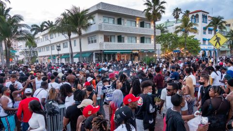 A large crowd of people participate in a party on a walkway near the beach, during spring break in Miami Beach on March 20, 2021