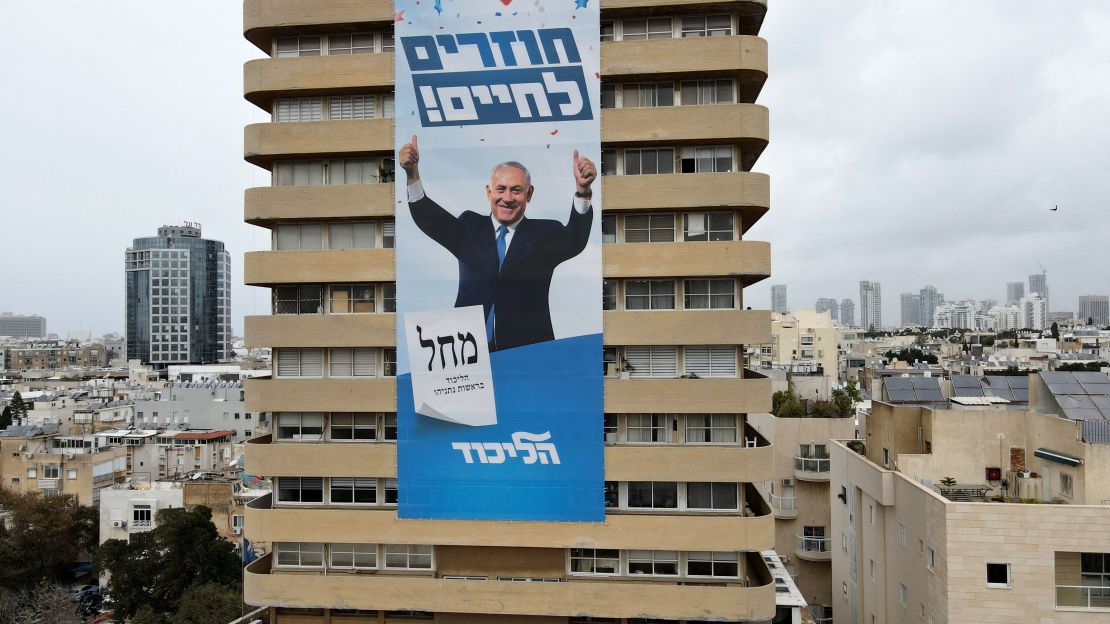 Netanyahu's campaign slogan "Come Back to Life" hangs on his Likud party headquarters in Tel Aviv.