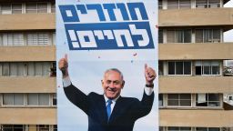 A campaign banner depicting Israeli Prime Minister Benjamin Netanyahu with the Hebrew slogan "Come Back to Life" hangs on a building hosting the headquarters of his Likud party in the coastal city of Tel Aviv, on March 11, 2021, ahead of the March 23 general elections. (Photo by JACK GUEZ / AFP) (Photo by JACK GUEZ/AFP via Getty Images)