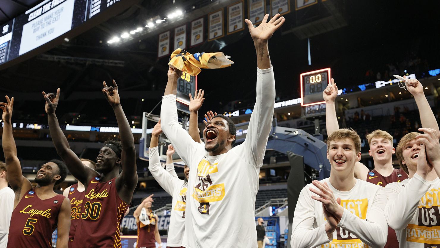 The Loyola Chicago Ramblers celebrate after defeating the Illinois Fighting Illini in the second round game of the 2021 NCAA Men's Basketball Tournament. 