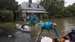 Residents unload household items from kayaks at a street submerged in floodwaters in Windsor, New South Wales, Australia, on Monday, March 22, 2021. Western Sydney and the NSW Mid-North coast are bearing the brunt of the relentless downpour that has caused the Warragamba Dam, Sydneys primary source of water, to overflow for the first time in five years, and caused severe damage to property and roads. Photographer: Brent Lewin/Bloomberg via Getty Images