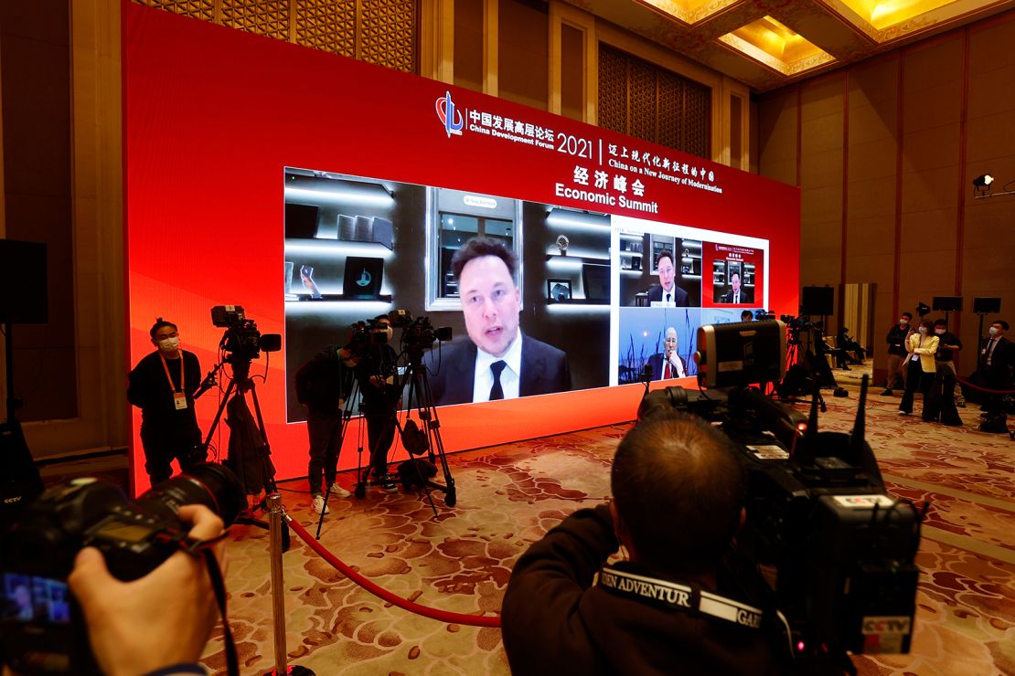 A screen showing Tesla CEO Elon Musk speaking via video link during the China Development Forum at Diaoyutai State Guesthouse on Saturday in Beijing.