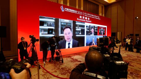 A screen showing Tesla CEO Elon Musk speaking via video link during the China Development Forum at Diaoyutai State Guesthouse on Saturday in Beijing.