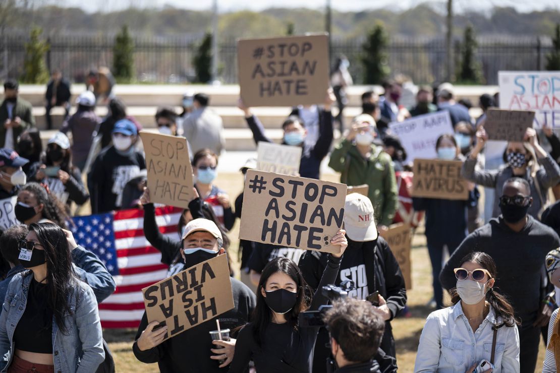 Demonstrators hold signs at a Stop AAPI Hate Rally outside the Georgia Capitol building in Atlanta on Saturday, March 20.