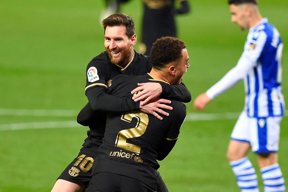 Dest celebrates with Messi after scoring a goal against Real Sociedad.