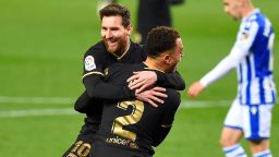 Barcelona's Barcelona's US defender Sergino Dest celebrates with Barcelona's Argentinian forward Lionel Messi (back) after scoring a goal during the Spanish League football match between Real Sociedad and Barcelona at the Anoeta stadium in San Sebastian on March 21, 2021.