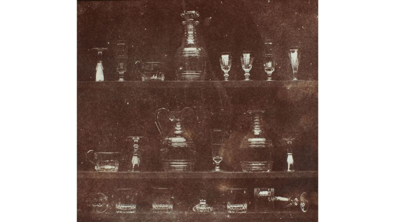 A photo titled "The Milliner's Window" shows a variety of objects arranged on temporary shelves.