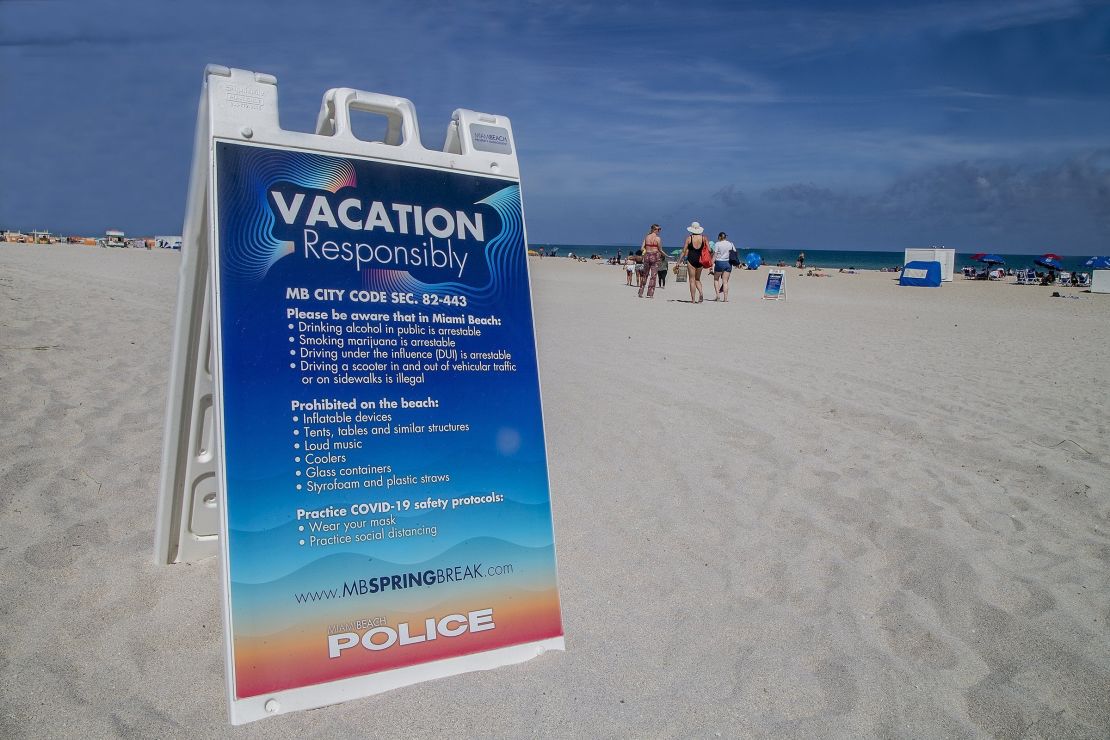 A sign on the beach earlier this month warns spring breakers to vacation safely.