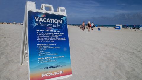 A sign on the beach earlier this month warns spring breakers to vacation safely.