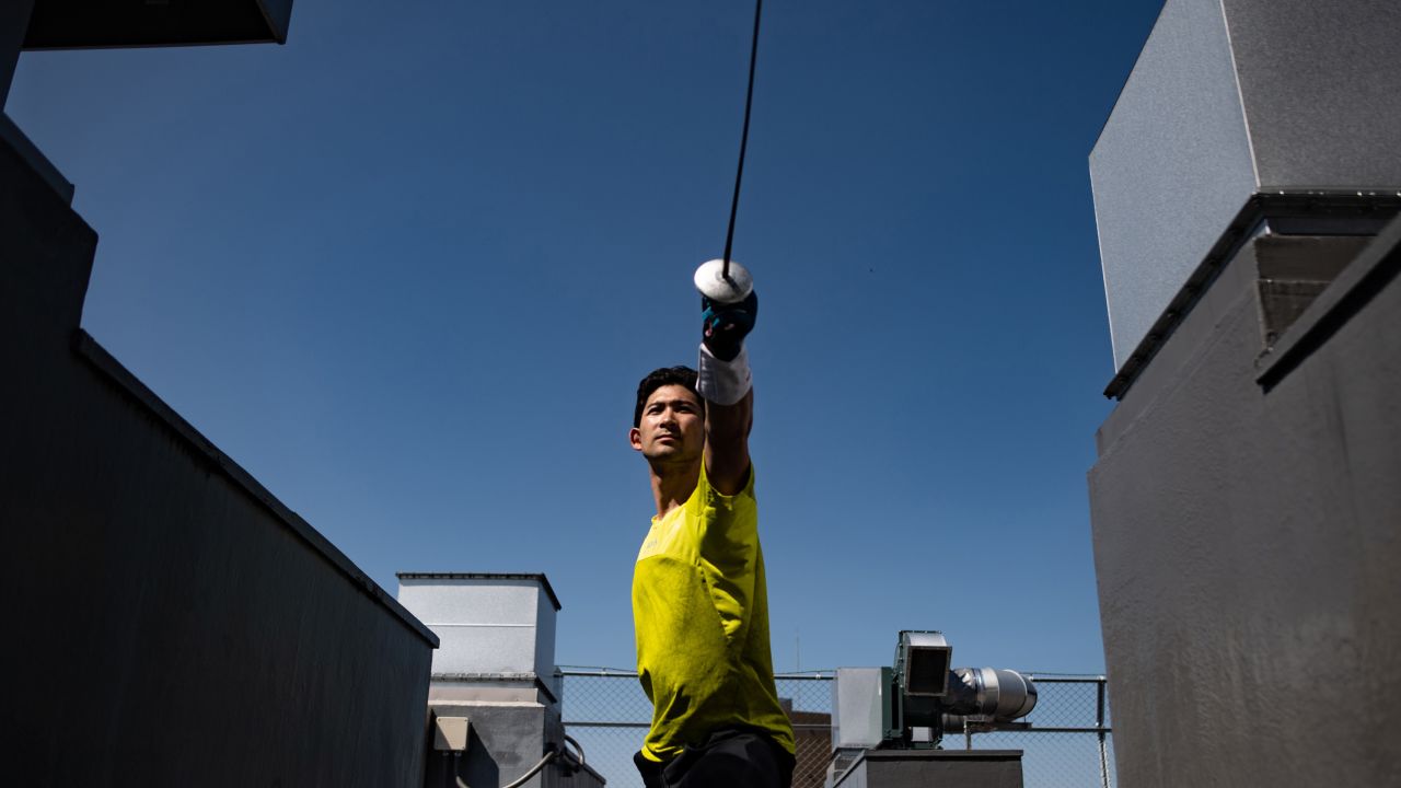 Miyake working out with a foil on the rooftop in Tokyo ahead of the postponed Olympics.