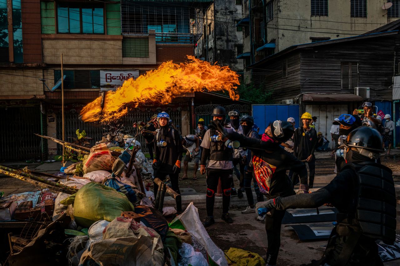 Protesters test Molotov cocktails in Yangon on March 16.