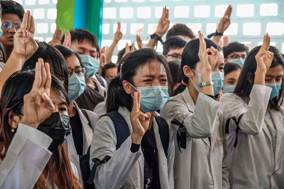 Medical students hold up the <a href="https://www.cnn.com/2014/11/20/world/asia/thailand-hunger-games-salute/index.html" target="_blank">three-finger salute</a> at the Yangon funeral of Khant Nyar Hein on March 16. The first-year medical student was fatally shot during the crackdown.