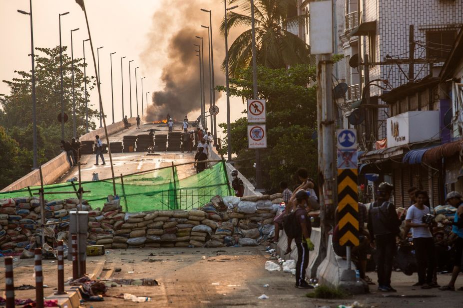 Protesters take positions on Yangon's Bayint Naung Bridge on March 17. The bridge was blocked with an improvised barricade to prevent security forces from crossing.