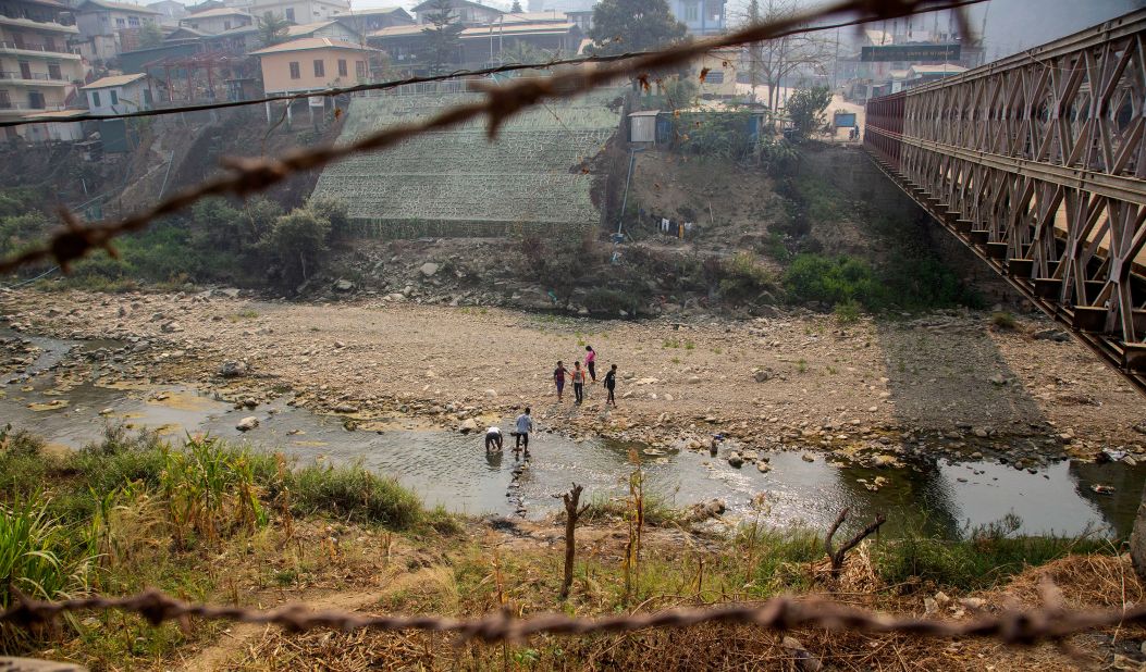 Unidentified people cross the Tiau River at the India-Myanmar border on March 20. Some people from Myanmar <a href="https://www.cnn.com/2021/03/11/asia/myanmar-india-mizoram-intl-hnk/index.html" target="_blank">have sought refuge in India</a> since the protests began.