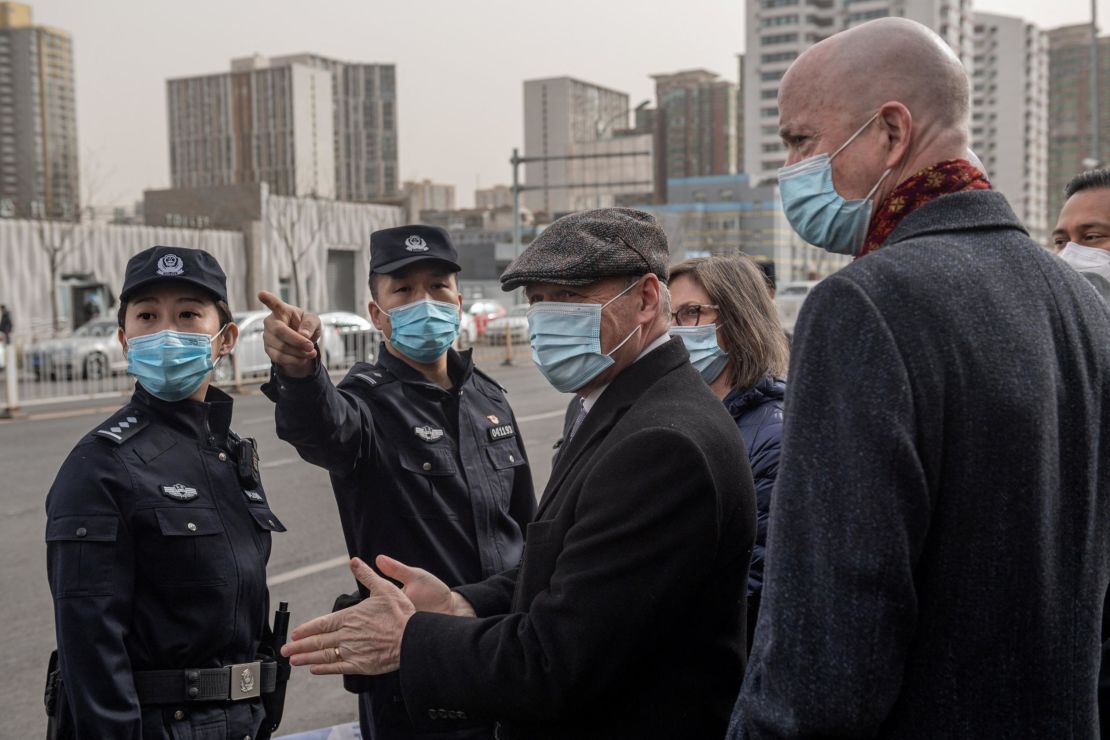 Police ask William Klein (R), acting deputy chief of mission at the US Embassy in Beijing, and Jim Nickel (C),  charge d'affaires of the Canadian embassy in Beijing, to move to another entrance as they stand with other diplomats outside the Beijing No. 2 Intermediate Court on March 22, 2021.
