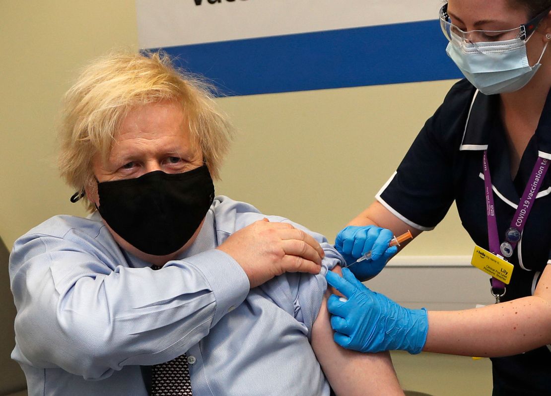 Britain's Prime Minister Boris Johnson receives his first dose of a AstraZeneca/Oxford Covid-19 vaccine, administered by nurse and Clinical Pod Lead, Lily Harrington, at rhe vaccination center in St Thomas' Hospital in London on March 19, 2021.