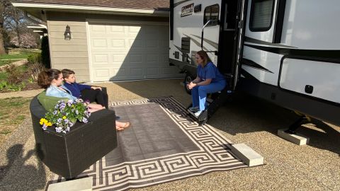 Dr. Tiffany Osborn would sit on the steps of the camper and visit with her family from a distance.
