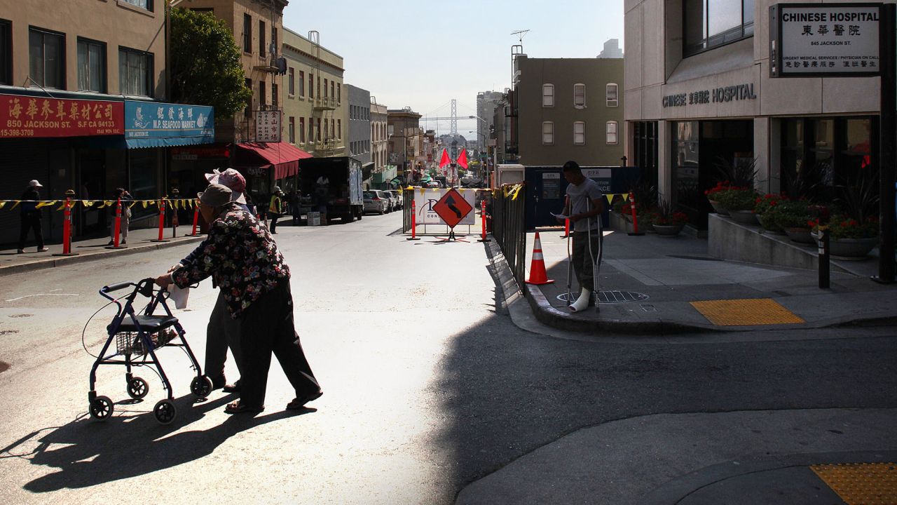 Pedestrians walk across the street from the Chinese Hospital in San Francisco on July 19, 2013.
