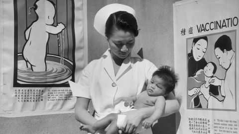 Nurse Minnie Sun holds a baby in 1933 at San Francisco's Chinese Hospital, the first Chinese-American health care in the continental US.  