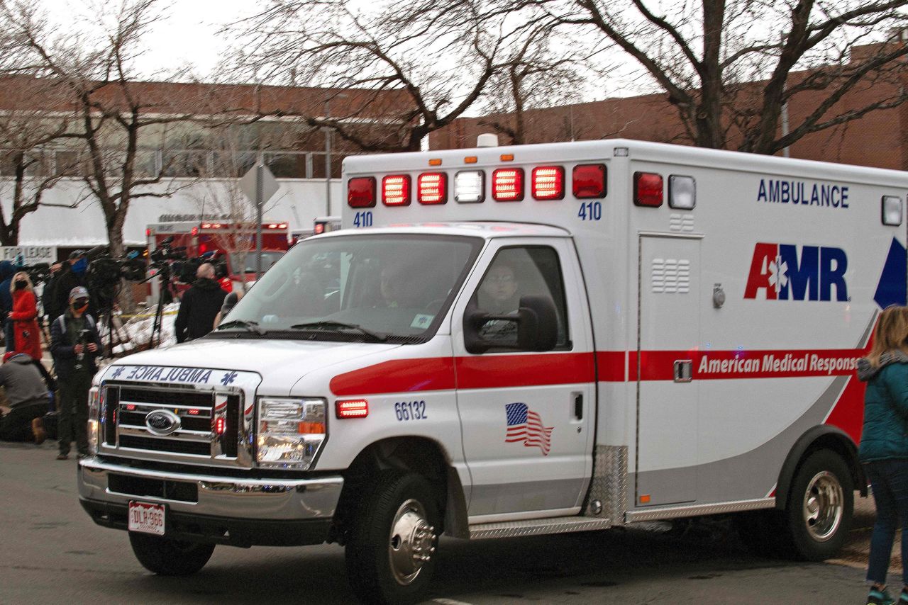 An ambulance leaves the store's parking lot.