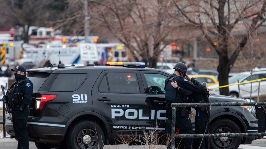 BOULDER, CO - MARCH 22:  Two police officers embrace after a gunman opened fire at a King Soopers grocery store on March 22, 2021 in Boulder, Colorado. Dozens of police responded to the afternoon shooting in which at least one witness described three people who appeared to be wounded, according to published reports.  (Photo by Chet Strange/Getty Images)