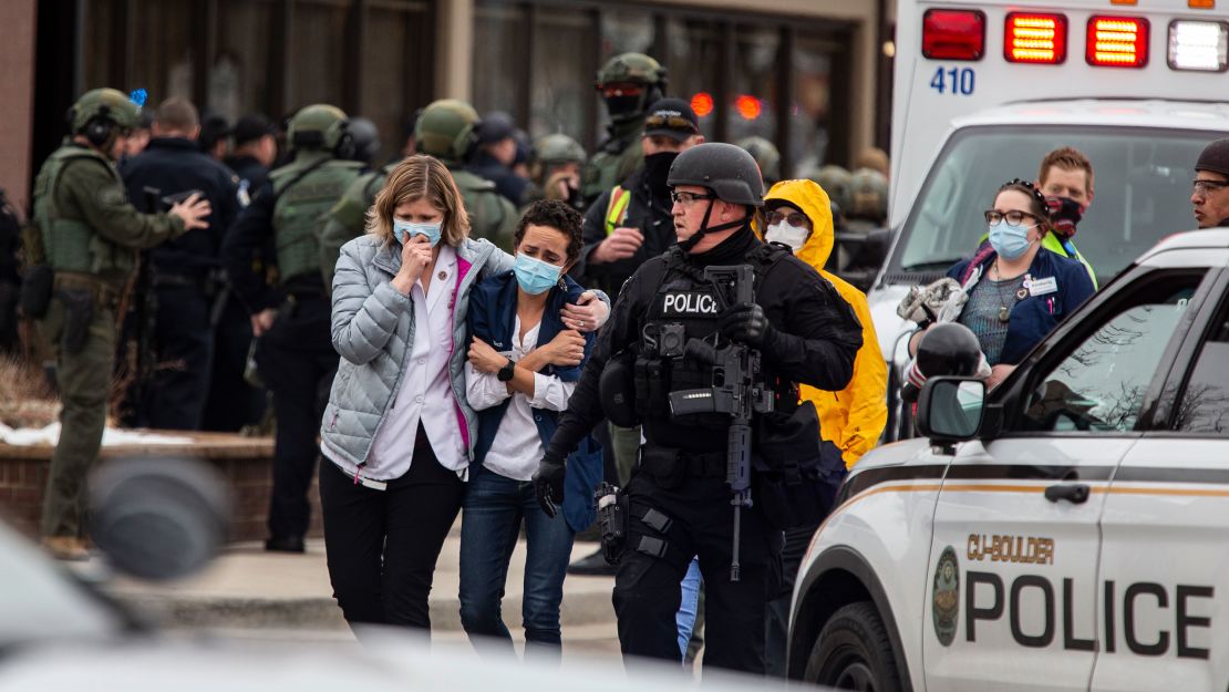  Healthcare workers walk out of a King Soopers Grocery store after a gunman opened fire on March 22, 2021 in Boulder, Colorado