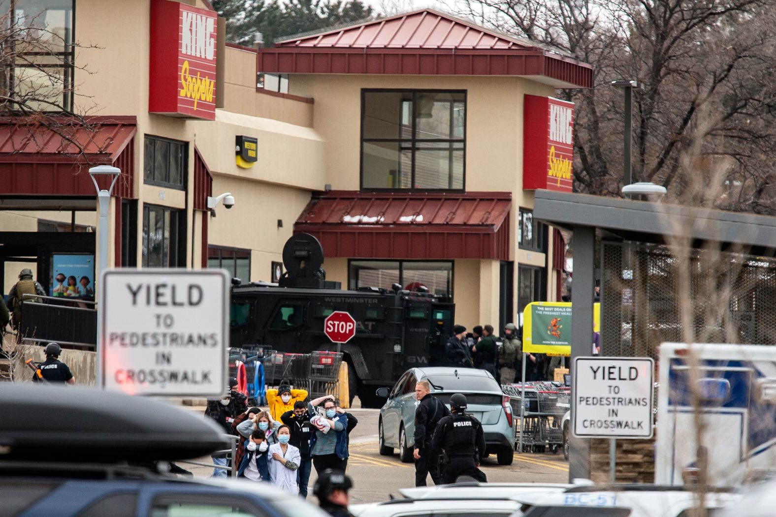 Shoppers are escorted to safety.