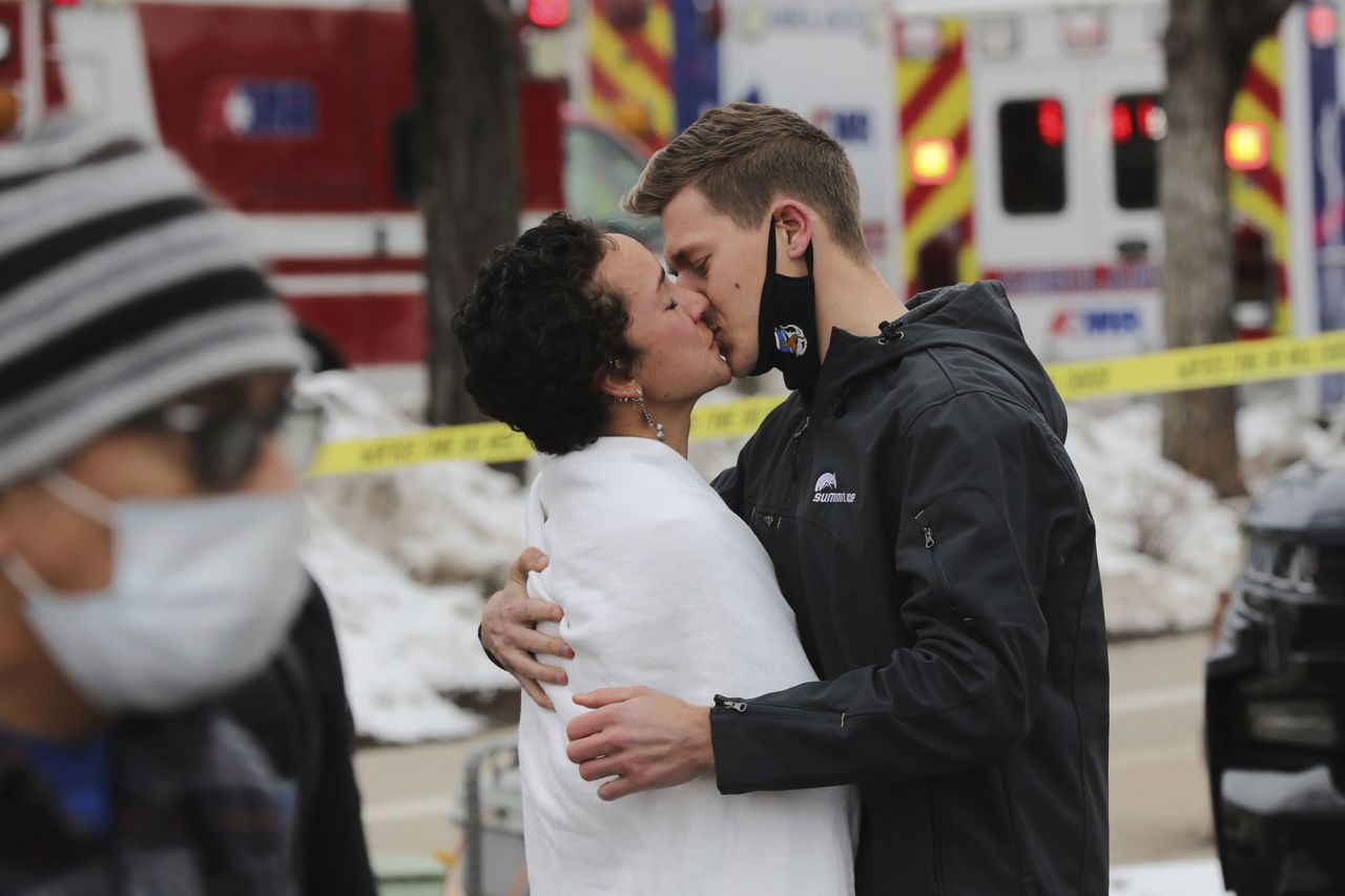 A man and woman kiss near the scene on Monday.