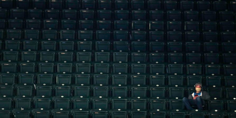 A fan sits in the stands during a second-round game in Indianapolis.