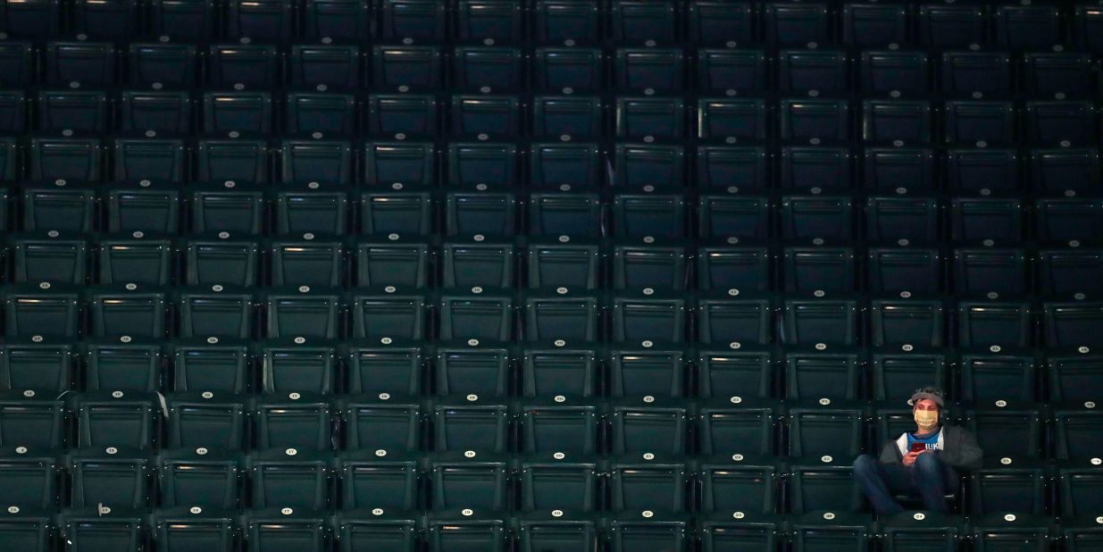 A fan sits in the stands during a second-round game in Indianapolis.